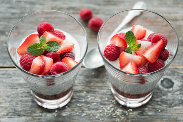 Protein chia pudding with fresh berries on wooden background. Top view, selective focus