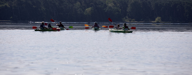 people enjoying kayaking on the river
