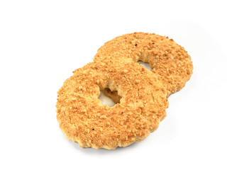 Two shortbread ring cookies with nuts. Sand ring with nuts isolated,white background. Shortcrust ring isolated on white with clipping path.Traditional Russian cake ring shortbread cookies with peanuts