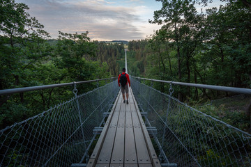 Traveler on the suspension bridge in Germany. Geierlay, Morsdorf.