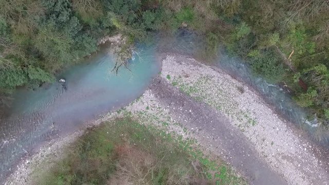 Top-down drone view of canyon and Khosta River in Yew and Box-tree Grove in spring day, Sochi, Russia
