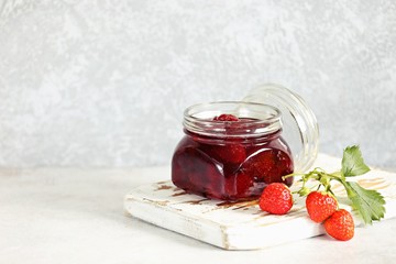 Strawberry marmalade. Homemade strawberry jam in glass jar overhead rustic wooden table. Copy space