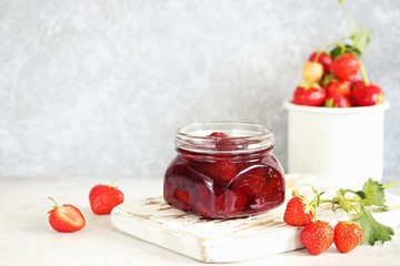 Strawberry marmalade. Homemade strawberry jam in glass jar overhead rustic wooden table. Copy space