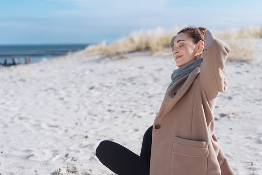 Woman spending a relaxing winter day at a beach
