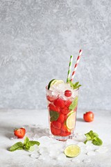 Strawberry infused water, coctail, lemonade or tea. Summer iced cold drink with strawberry, lemon and mint. Selective focus 