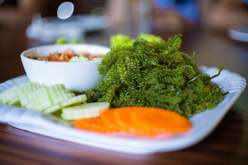 Thai spicy papaya salad with seaweed caviar or sea grape
