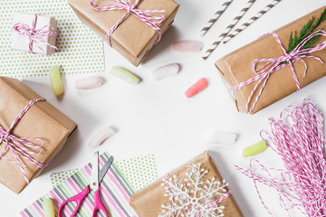 Boxes with gifts in festive packing, preparing for holiday christmas birthday on light background top view with copy space