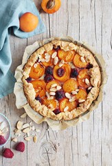 Tart with apricots and raspberry. Summer berries dessert. Overhead view.