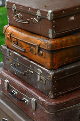 Stack of old vintage travel suitcases close up