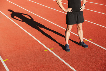 Fototapeta na wymiar Cropped image of a sportsman finished running