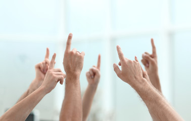 business team pointing fingers up