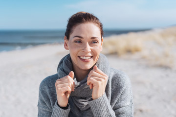 Attractive woman on a sunny beach in cold weather