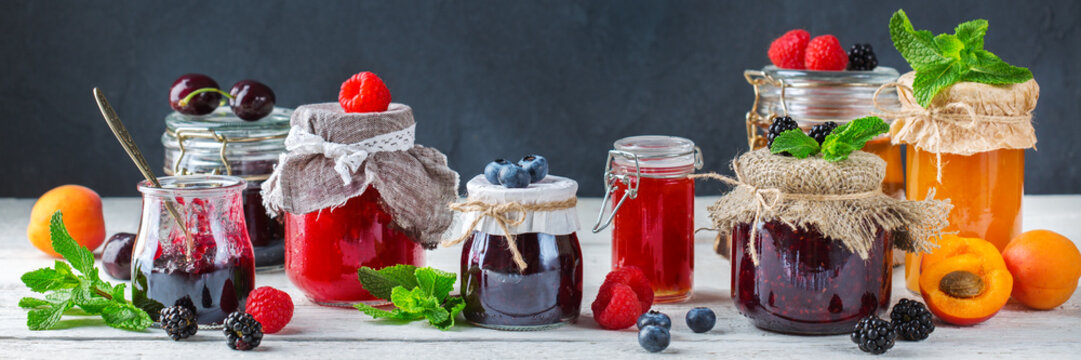Assortment of seasonal berries and fruits jams in jars