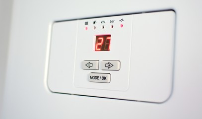 Control panel of the electric boiler with display and control buttons.