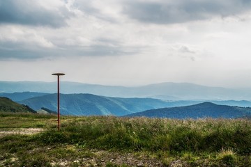 A pillar on the tourist trail in the mountains. Carpathians. Ukraine.