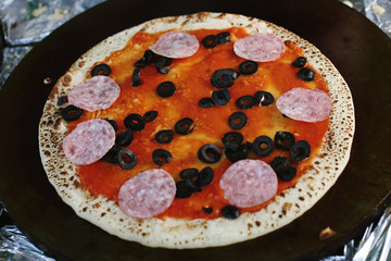 Pancake-pizza, an unusual preparation using dough for pancakes. Street food, cooking stages.
