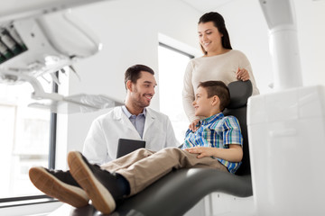 medicine, dentistry and healthcare concept - mother and son visiting dentist at dental clinic - Powered by Adobe