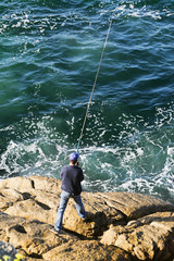 Fototapeta na wymiar angler fisherman fishing in sea coast