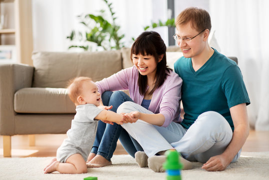 Family, Parenthood And People Concept - Happy Mother And Father With Baby Boy At Home