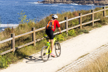 cyclist on bicycle in seafront lane