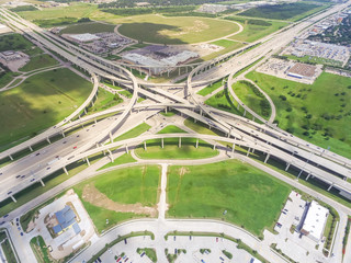 Aerial view Interstate 10 or Katy freeway with massive intersection, stack interchange, elevated road junction overpass in daytime. Nightly degree vertical view metropolitan area of Katy, Texas, USA - obrazy, fototapety, plakaty