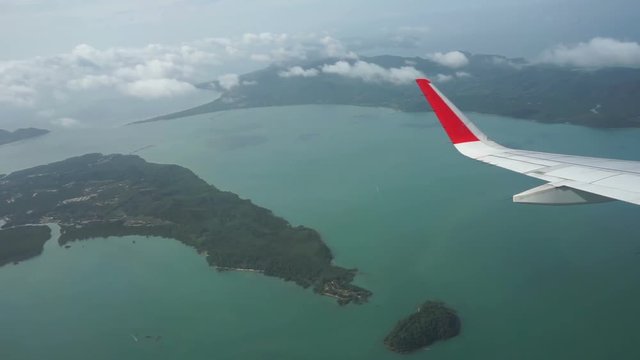 View through an airplane window on the tropical island