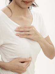 Woman examining herself for breast cancer