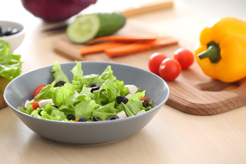 Bowl with fresh salad on table. Diet food