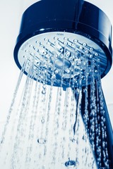 Shower Head with Water Stream on Grey Background