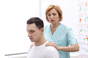 Orthopedist examining patient in hospital