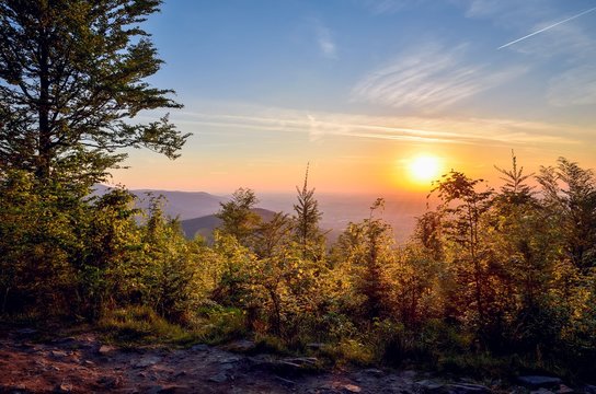 Beautiful mountain landscape. Sunset over the hills and cities.