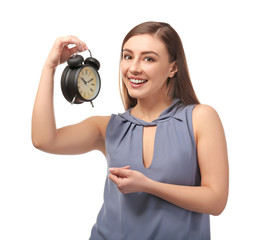 Fototapeta premium Young woman with alarm clock on white background. Time management concept