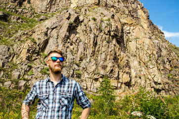 Young traveler on a mountain background.