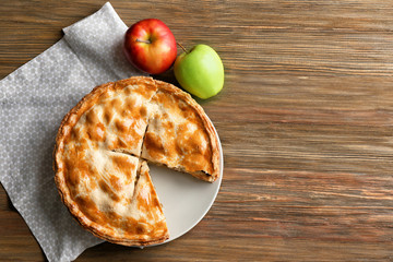Tasty homemade apple pie on wooden table