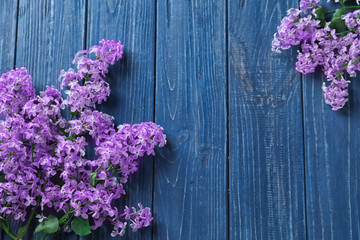 Beautiful blossoming lilac on wooden background