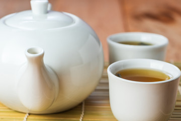 close-up of white chinese tea set on bamboo, selective focus