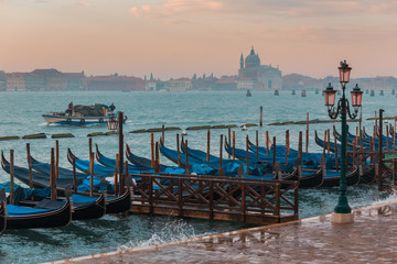 Fototapeta na wymiar Morning in Venice. Gondolas at the pier. Italy.