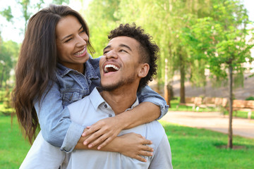 Fototapeta premium Happy African-American couple in park on spring day