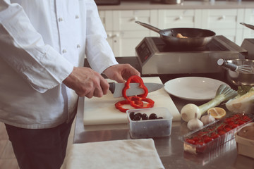 Male chef cutting vegetables in restaurant kitchen