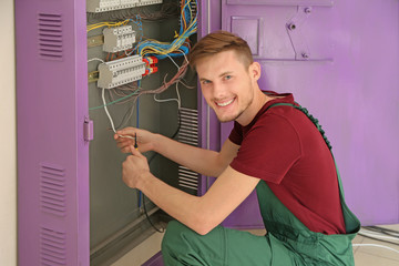 Electrician repairing distribution board