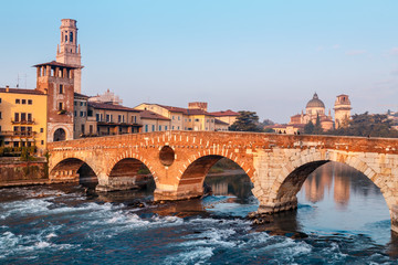 Obraz premium City view of Verona with the Dom Santa Maria Matricolare and Roman bridge Ponte Pietra on the River Adige in Verona. Italy. Europe.