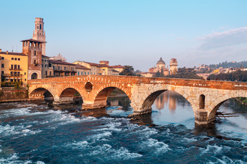Fototapeta premium City view of Verona with the Dom Santa Maria Matricolare and Roman bridge Ponte Pietra on the River Adige in Verona. Italy. Europe.