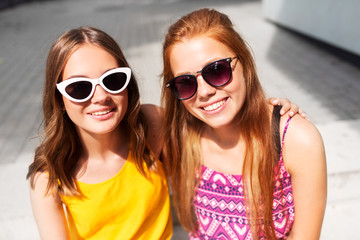 summer fashion, eyewear and people concept - smiling teenage girls in sunglasses outdoors