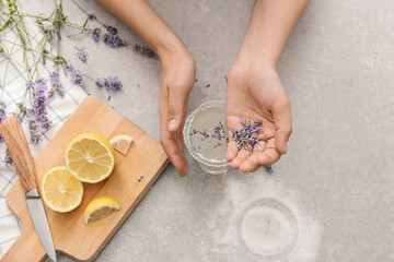 Young woman preparing lavender lemonade, closeup