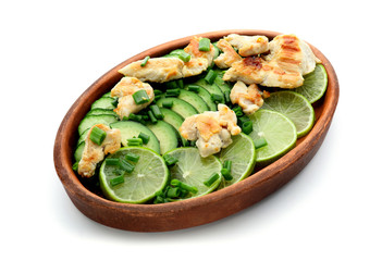 Salad with ripe avocado, chicken and lime on white background