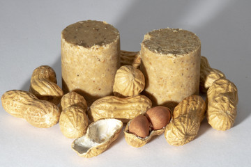 Pacoca and peanuts isolated on white background. Peanut macro.