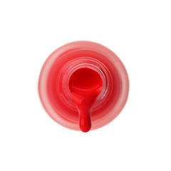Open bottle with dripping nail polish on white background