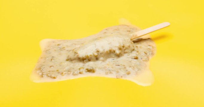 studio shoot of green bean popsicle melting and reverse time lapse on yellow background