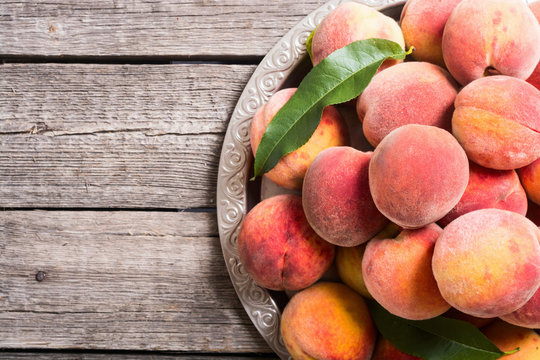 Ripe peaches fruit on rustic background