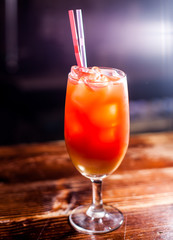 red coctail on a table desk, dark background